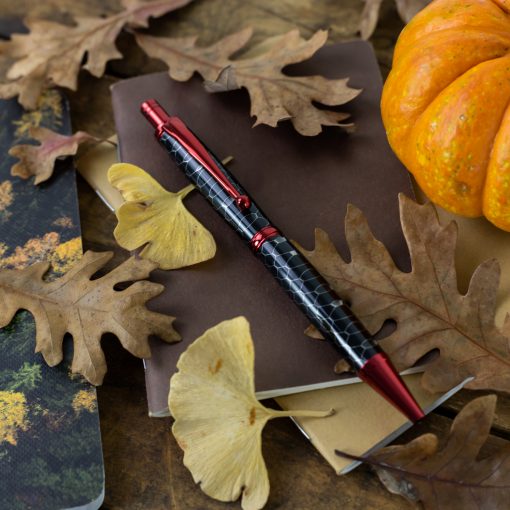 Slim Max 2.0 Click Pen Kit in Red from William Wood-Write turned with "Python" Honeycomb pen blank against fall background.