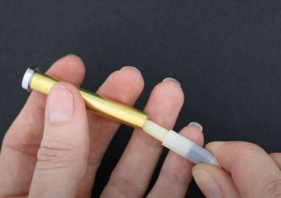 Click mechanism partially inserted into the upper barrel of the slim max 2.0 click pen from william wood-write ltd. using parker-style ink refill.