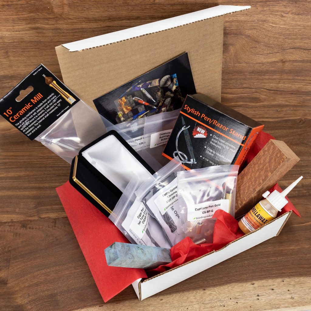 Premium Monthly Subscription Box from William Wood-Write Ltd containing pen/razor stand, ceramic mill project kit, cigar pen kit, capstone pen kit, and shellawax polish.