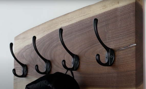 Wall-mounted coat hanger made with black walnut charcuterie board inlaid with synthetic opal material from William Wood-Write Ltd.