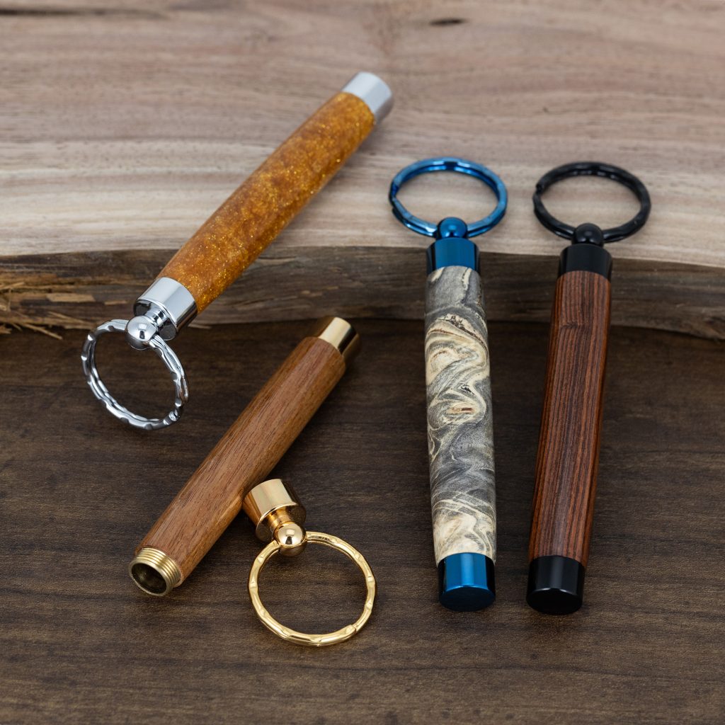Four handmade wood turned secret compartment keychains
