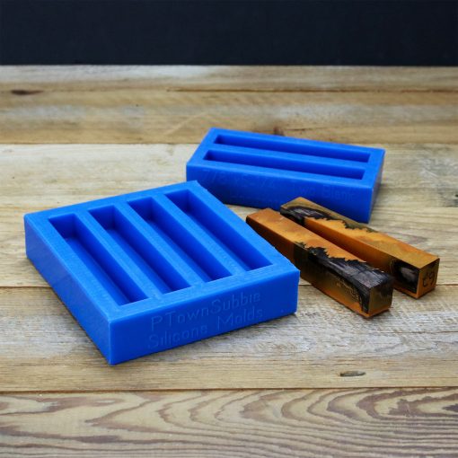 Two blue silicone molds used for casting resin pen blanks beside two brown and black pen blanks.