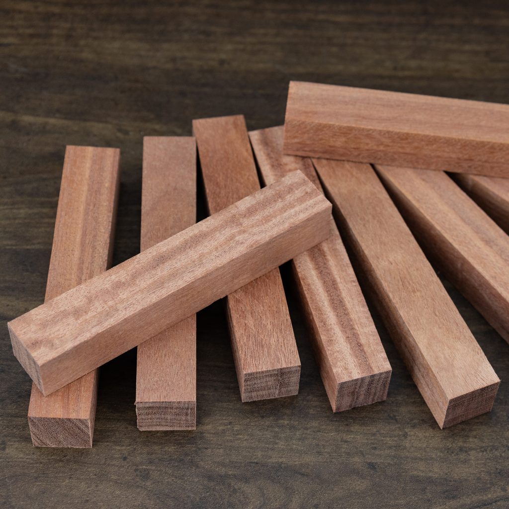 Ten pen blanks made of cabreuva wood on a dark brown background