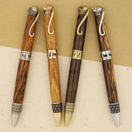 Four handmade wooden pens with cat designs