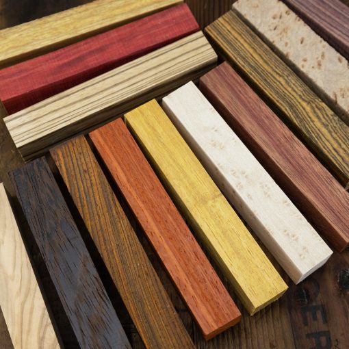 An assortment of different exotic wood pen blanks in different colours and textures