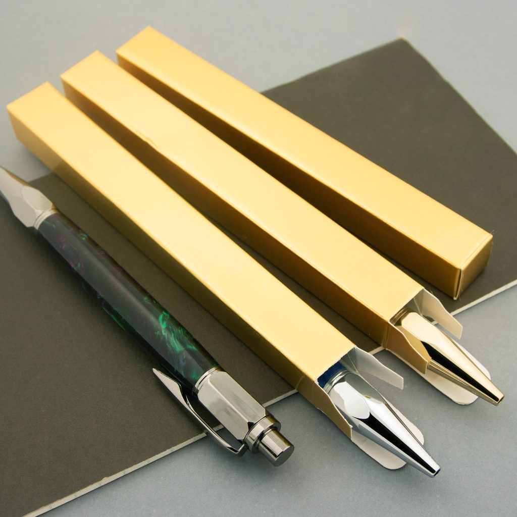 slender golden boxes with handmade fountain pens inside