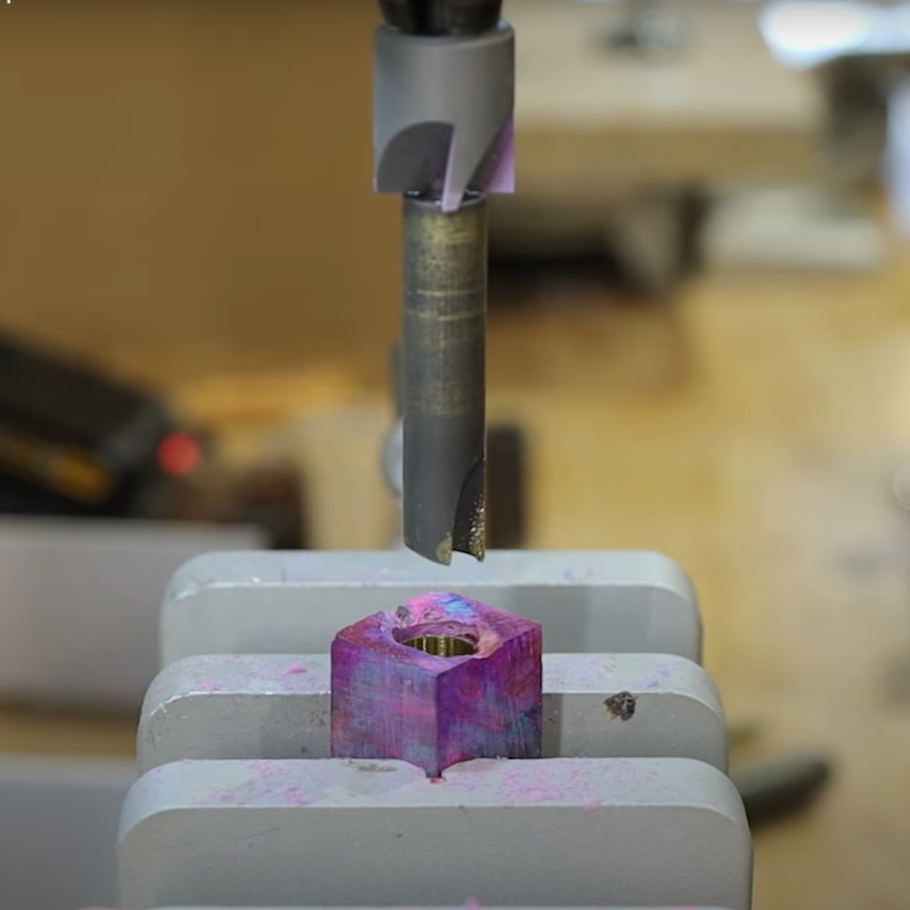 A drill press with pen mill and cutterhead installed, showing how to square up a pen blank