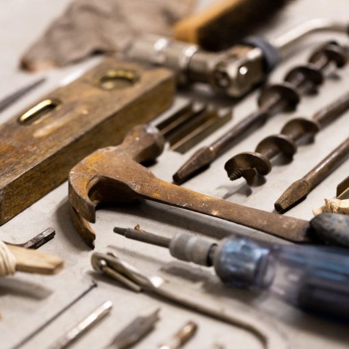 A selection of tools including drill bits, a hammer, level and screwdriver