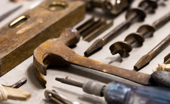 A selection of tools including drill bits, a hammer, level and screwdriver