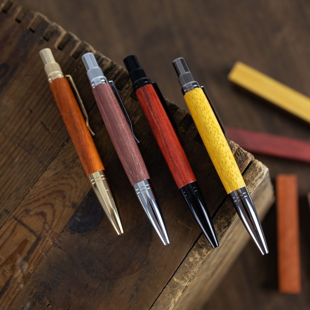 Four wooden pens made by hand on a lathe in different colours.