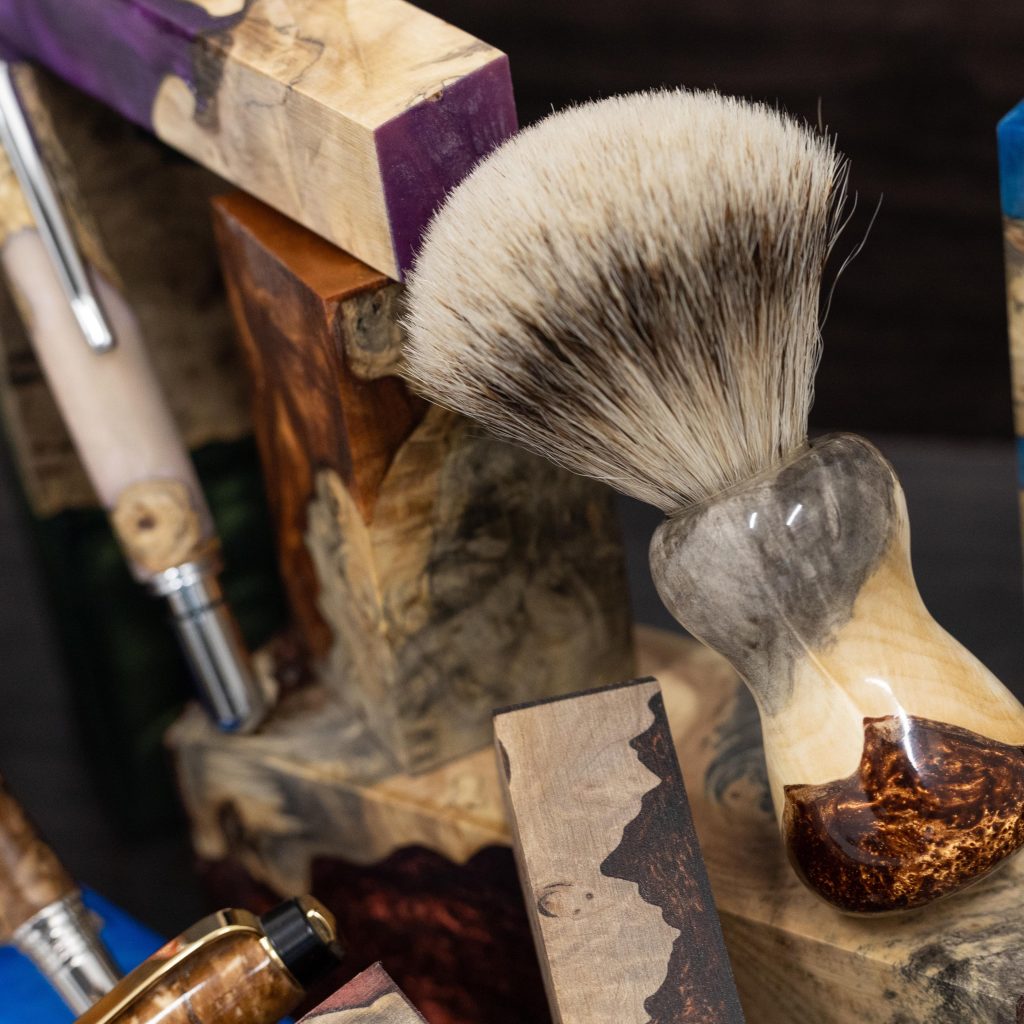 Close up of a custom handmade shaving brush and pen made on a woodlathe