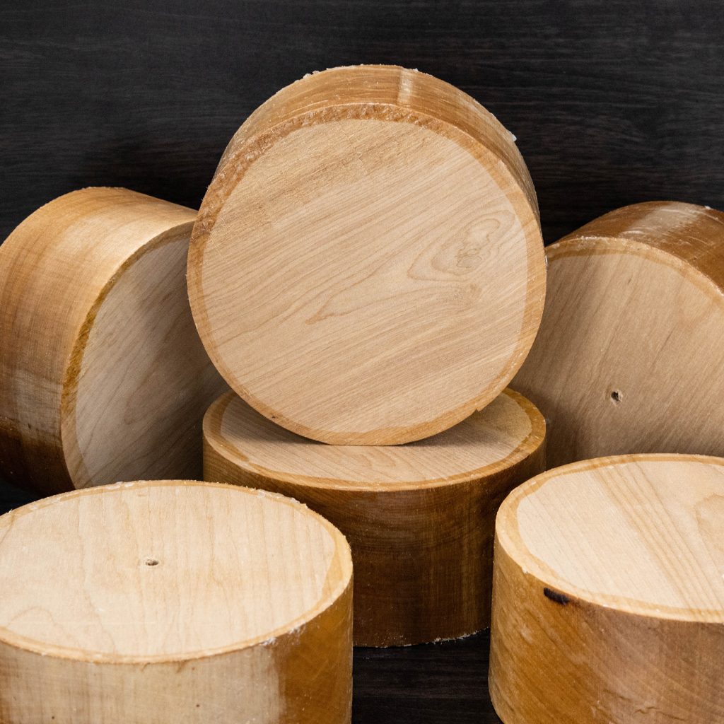 A selection of round peices of yellow birch wood for bowl turning